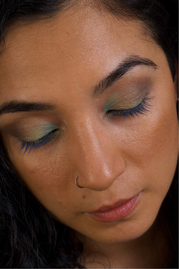 various shade eyeshadow look including blue, green pink and brown hues
