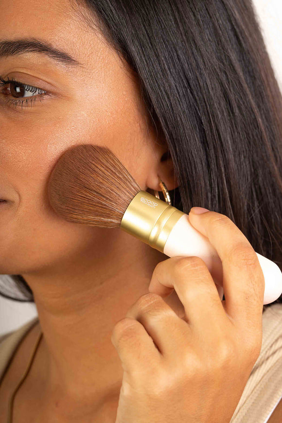 Scoop Whole Beauty ultra soft vegan kabuki brush used by model with our natural mineral powder foundation - tan