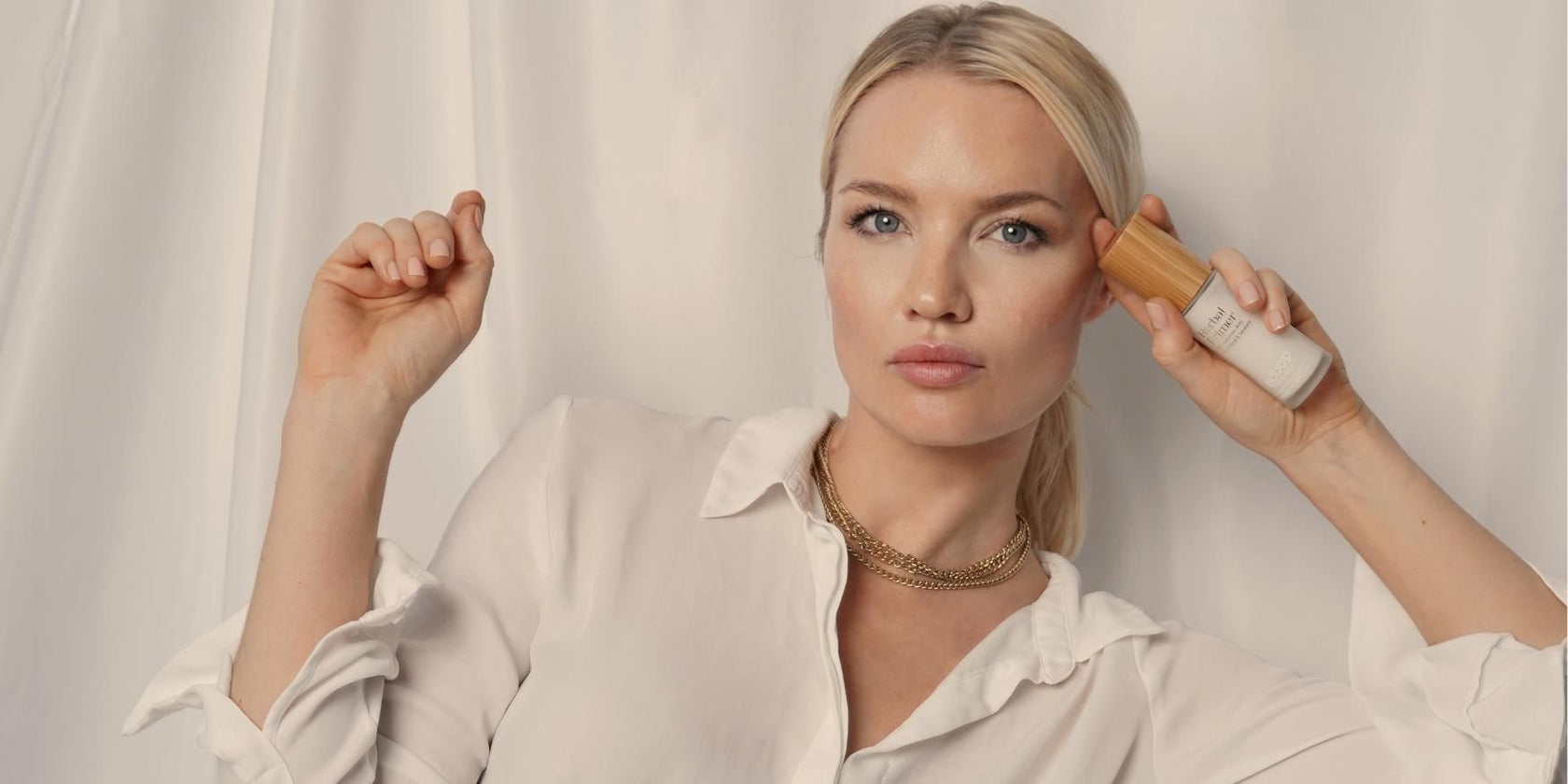 a woman holding the scoop whole beauty herbal primer