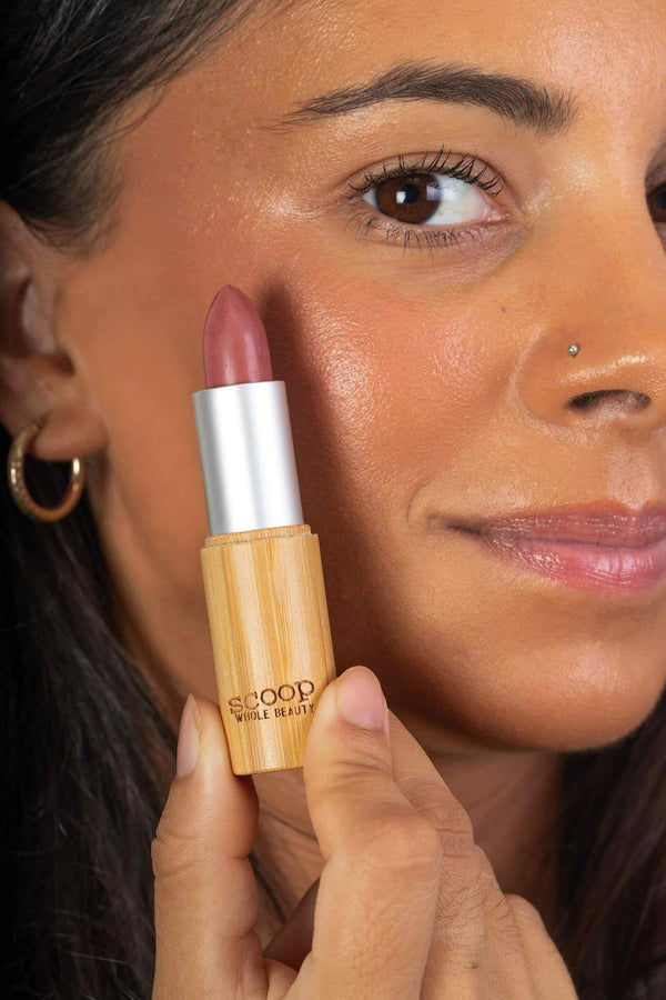 Scoop Whole Beauty model applies natural rose lipstick as blush  -rose