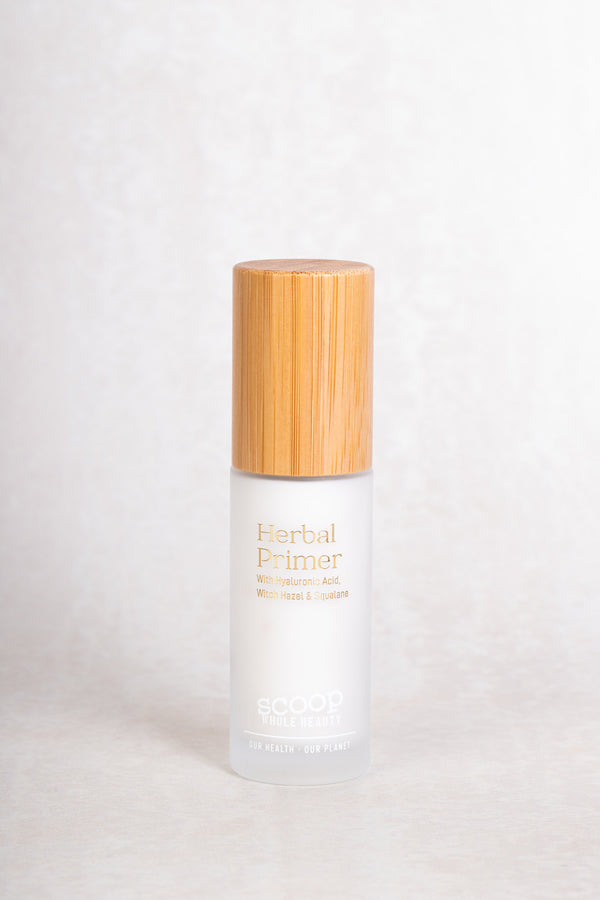 Scoop Whole Beauty natural herbal primer with witch hazel, displayed in refillable, sustainable, glass and bamboo bottle