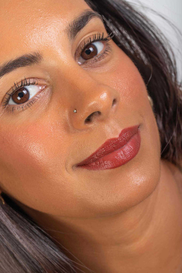 Scoop Whole Beauty model, Naomi, showcases her simplistic look with our natural mud cake mascara, cherry lip stick, also used as cheek tint, and HLA infused mineral liquid cover foundation - maca - medium - tan - cocoa
