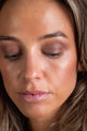 model looking down showing eyeshadow on lid - midnight black - espresso brown