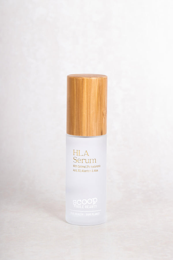 Scoop Whole Beauty HLA serum displayed in eco, sustainable, refillable glass and bamboo bottle