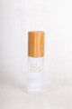 Scoop Whole Beauty HLA serum displayed in sustainable, refillable, glass and bamboo bottle