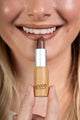 Scoop Whole Beauty model wears natural lipstick in sustainable bamboo tube- nude