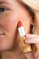 Scoop Whole Beauty model wears natural lipstick as cream blush- peach