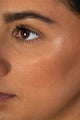 Scoop Whole Beauty model wears sun-kissed natural mineral bronzer and non-toxic, eco, mud cake mascara