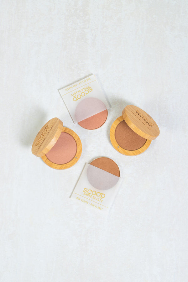 Scoop Whole Beauty natural mineral bronzer and pure pink blusher displayed in the sustainable 100% bamboo eco compact and the refill plate