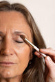 Scoop Whole Beauty vegan round eyeshadow brush applying natural mineral eyeshadow on model. Ultra soft makeup applicator.