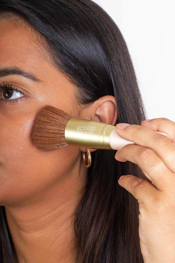 Scoop Whole Beauty model applies mineral liquid cover with ultra soft vegan foundation brush