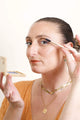 Scoop whole beauty is applying the mud cake mascara on her lashes with the shade ocean blue