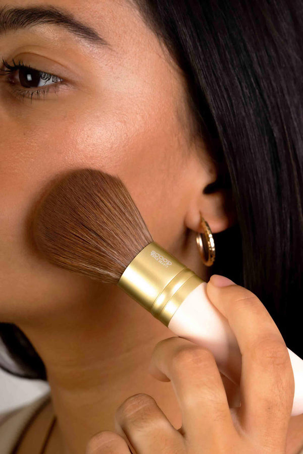 Scoop Whole Beauty model applies our natural mineral foundation with spf using the ultra soft vegan kabuki brush