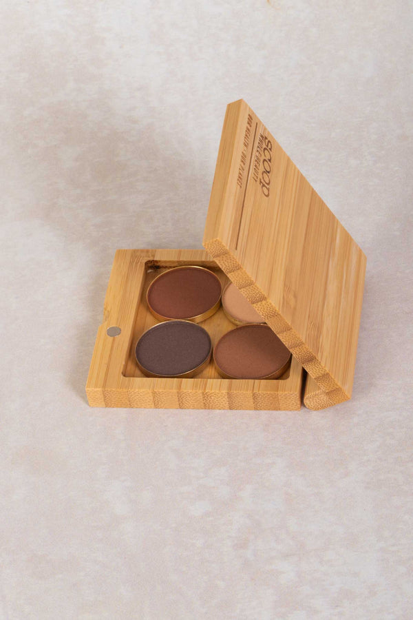 small bamboo makeup compact filled with 4 gold plates of pressed eyeshadows in warm natural tones - light - maca - walnut - medium - tan 