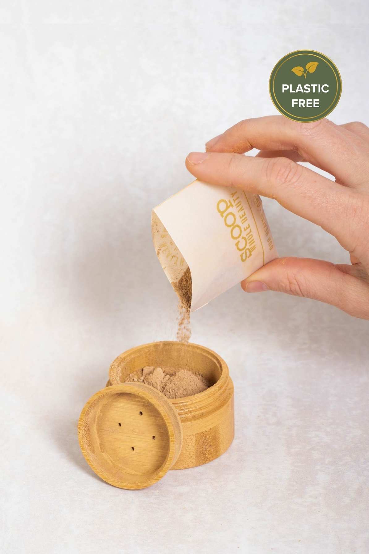 Scoop Whole Beauty full loop pure mineral powder foundation with SPF poured into sustainable, refillable, bamboo compact