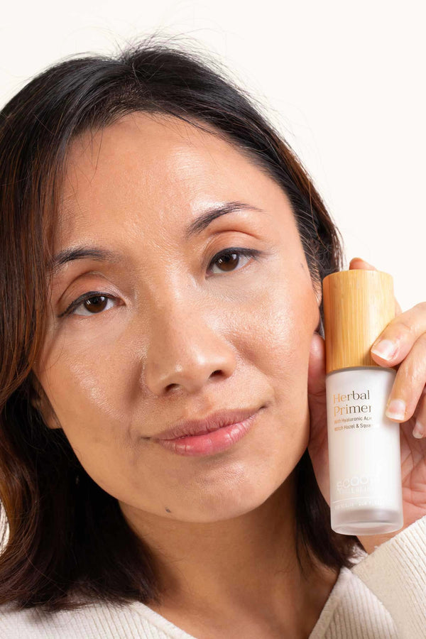Scoop Whole Beauty Model displaying radiant, glowing skin after applying natural, hydrating herbal primer