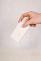 mud cake mascara refill box held in a hand
