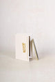 empty mud cake mascara refill box with the refill plate standing upwards alongside it and leaning against it - midnight black