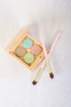 A bamboo eyeshadow quad with 4 gold plated pressed eyeshadow shades and 2 eyeshadow brushes.