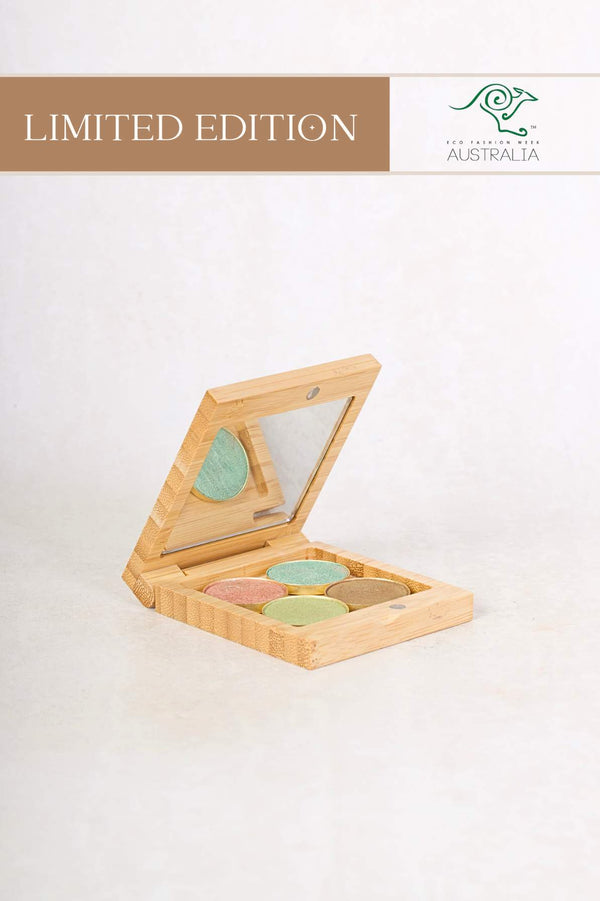Scoop Whole Beauty's Coral Reef Eyeshadow Palette in its open bamboo compact showing the 4 eyeshadow shades in a gold colored pan.
