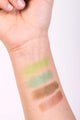 A hand swatch of the Scoop Whole Beauty's Limited Edition Eyeshadow palette Coral Reef. Starting from the top is Moss, Aqua, Siren, and Coral.