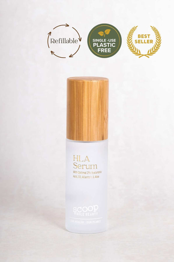 glass 35ml bottle of natural hyaluronic acid serum. FSC certified bamboo lid with frosted glass bottle and gold and white printing. refillable bottle with lotion pump.