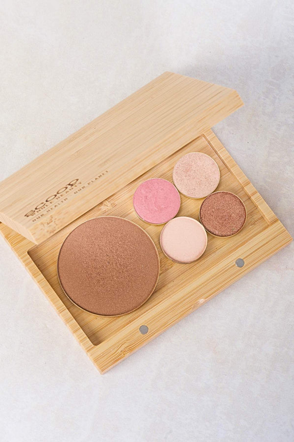 A close up of the palette that is opened showing the gold colored pans of bronzer and four eyeshadows.