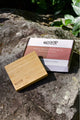The bamboo palette and box packaging placed on top of the rock.